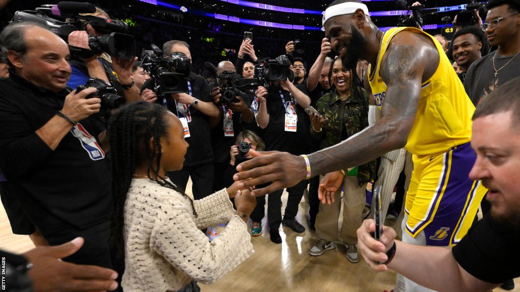 Lebron James about to hug his daughter Zhuri on court