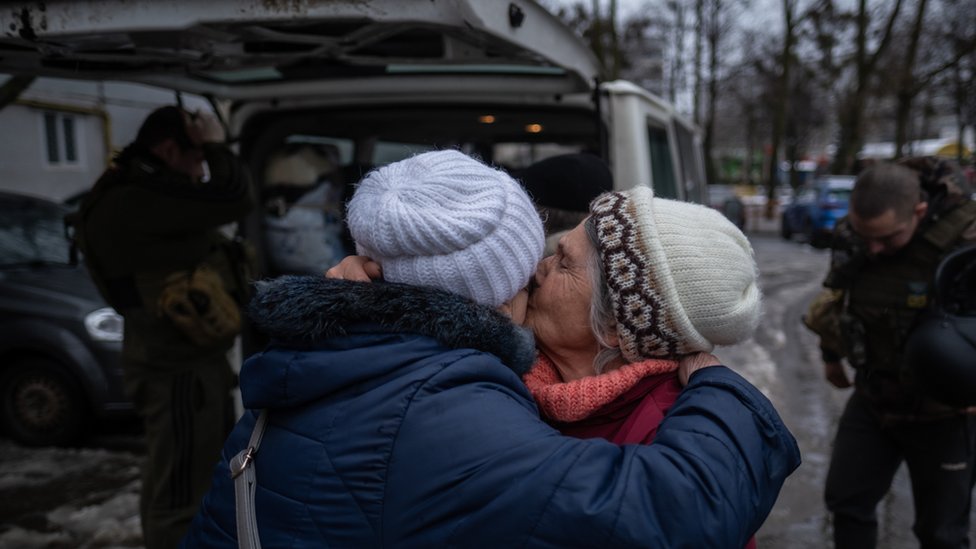 Elderly women hug after evacuation from Kupiansk, north-eastern Ukraine. Photo: 27 February 2023