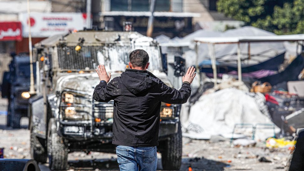 A Palestinian youth makes gestures in front of the vehicles of the Israeli army during the clashes at the vegetable market in the old city of Nablus in the occupied West Bank.