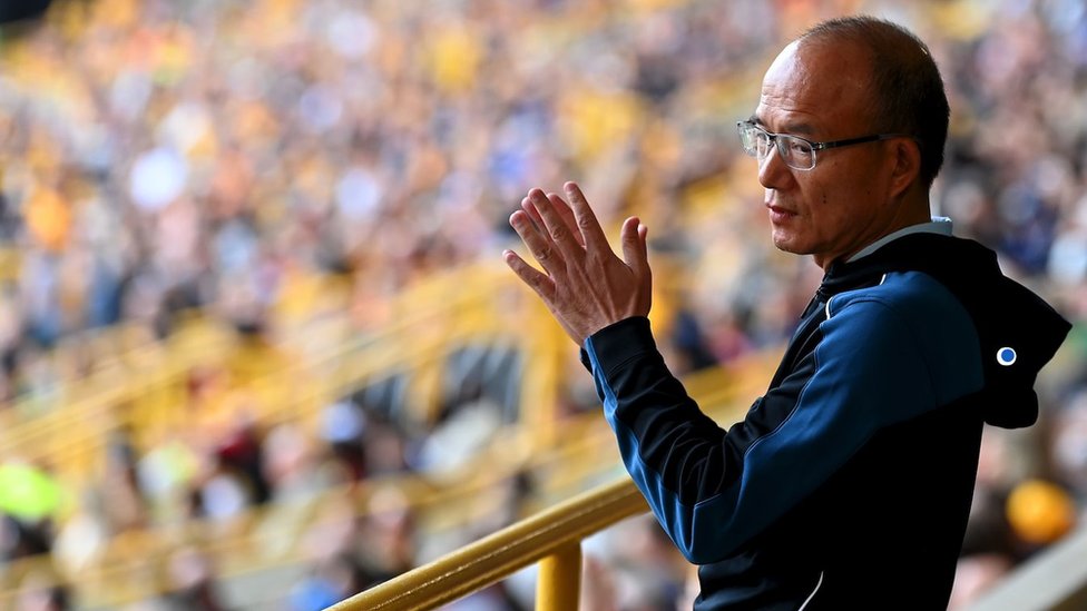 Guo Guangchang clapping while in the football stands