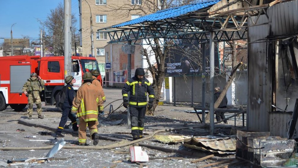 Rusija i Ukrajina: Ruski raketni napadi širom Ukrajine - nuklearna elektrana bila bez struje, korišćene i hipersonične rakete 1 Rescuers work at a bus stop which was hit during a rocket attack in Kherson