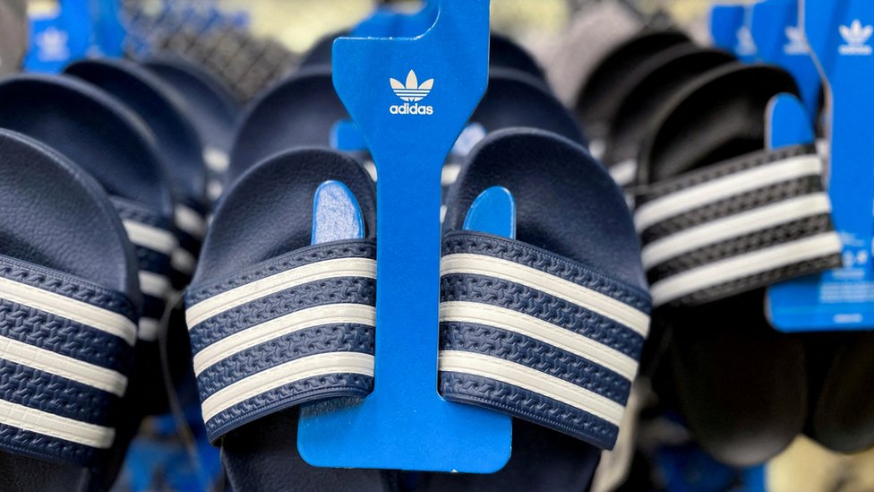 Adidas merchandise on display in a shop.