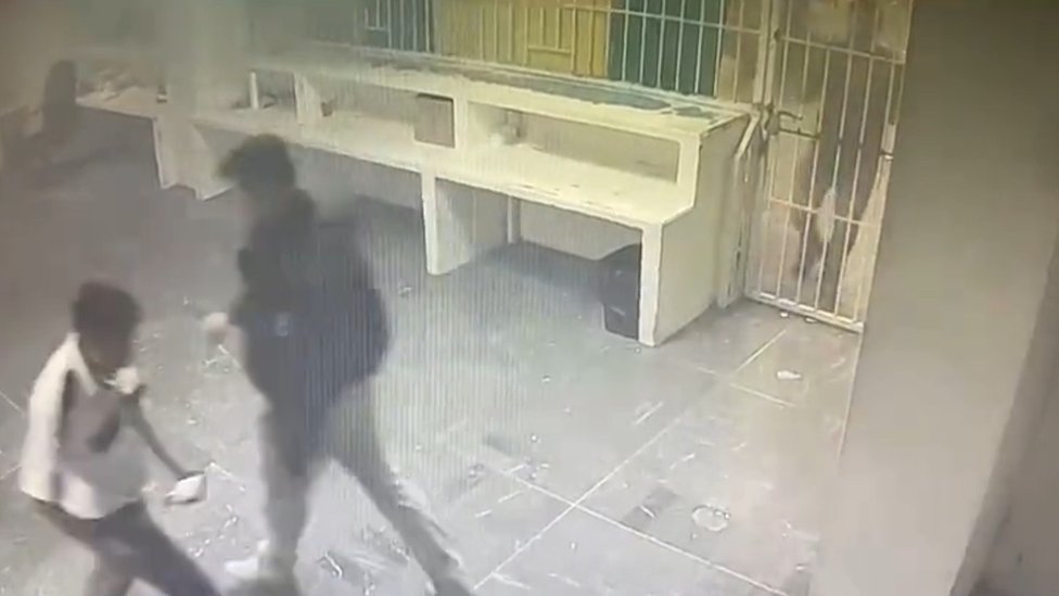 Still image from a video which appears to show staff not opening a locked door