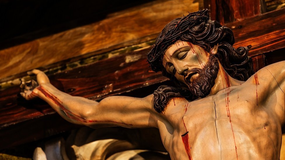 A church statue of Christ bleeding on the cross