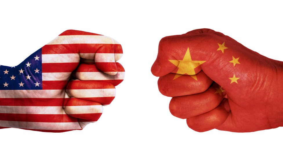 Hands painted in the flags of China and the US