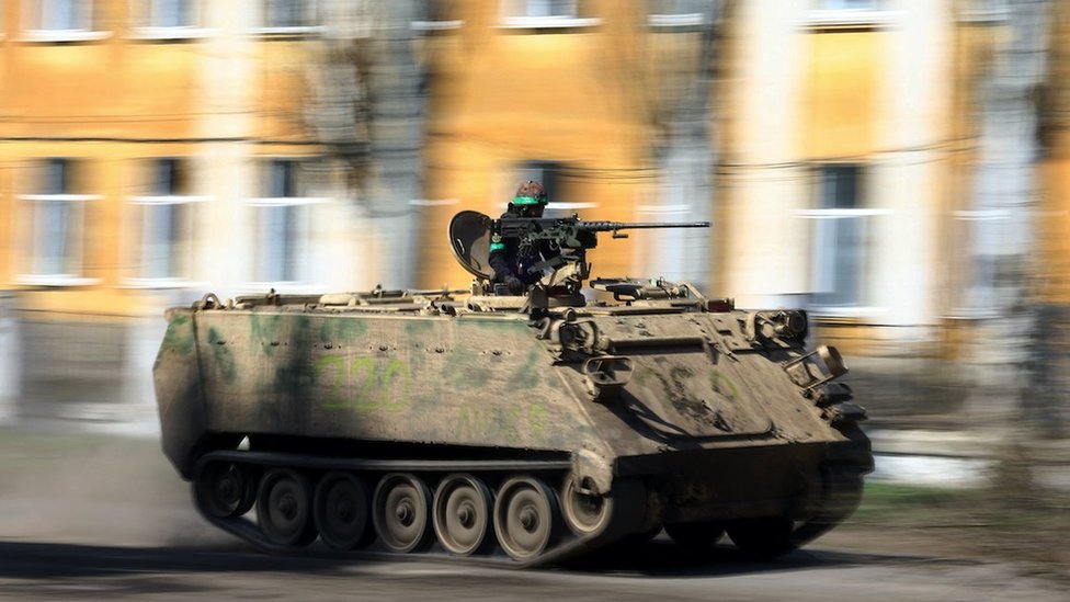 An armoured military vehicle speeds through Chasiv Yar during heavy fighting at the frontline of Bakhmut and Chasiv Yar, Ukraine, April 10, 2023. REUTERS/Kai Pfaffenbach