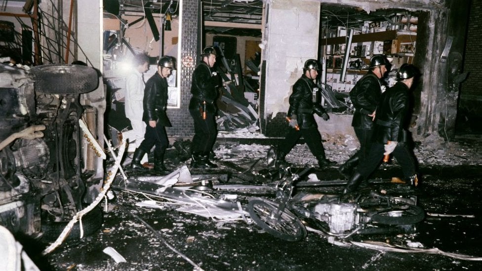 Rescue team members stand amid car wreckages after a bomb exploded on October 03, 1980 at the synagogue rue Copernic in Paris