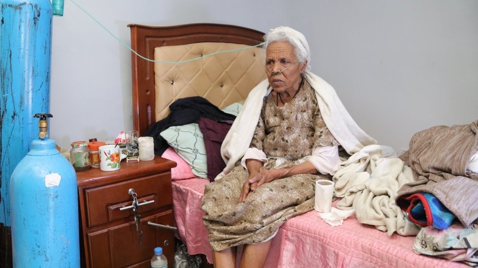 84-year-old Ethiopian woman Meseret Addis at home with a nasal cannula giving her oxygen