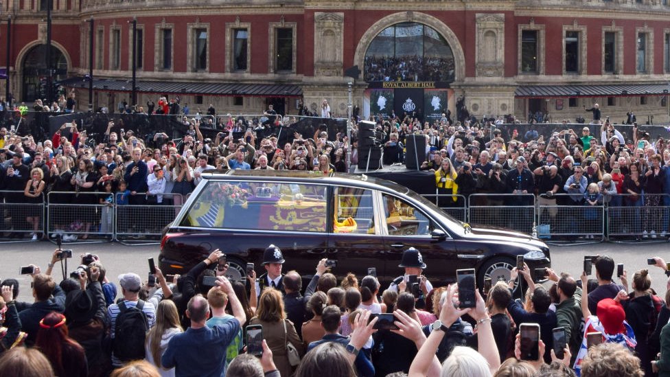 Crowds line the streets as the Queen's hearse drives past