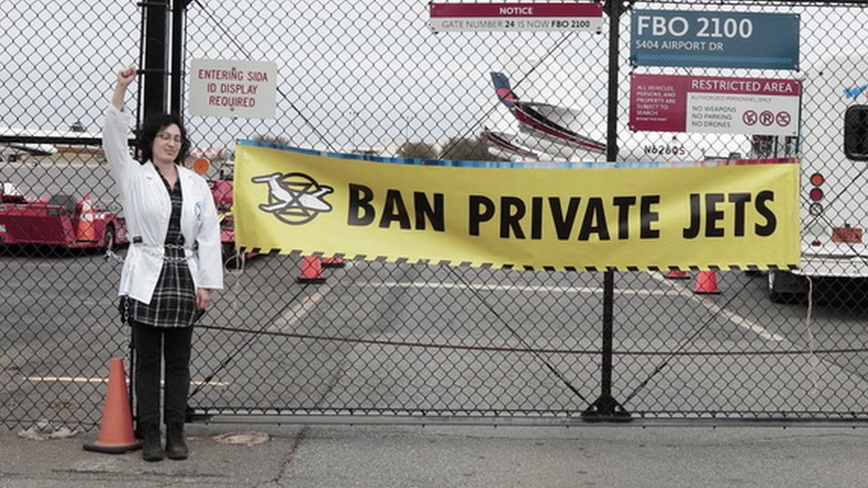 Scientist Rose Abramoff protesting at an airport demanding ban on private jets