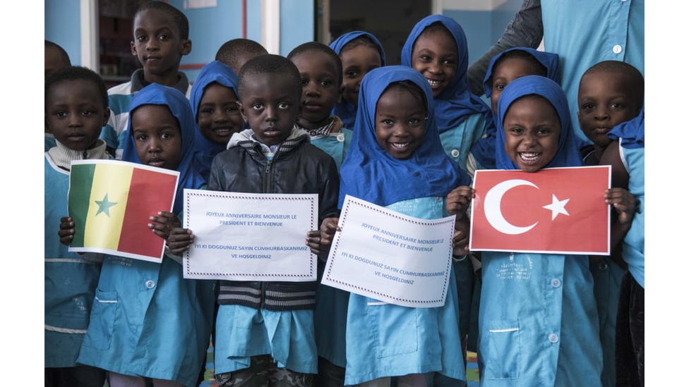 Children at a school in Senegal welcome President Erdogan with a picture of the Turkish flag during his 2018 visit to the country