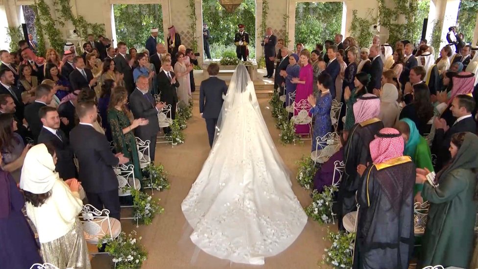 Rajwa Al Saif walks with Jordan's Prince Hashem bin Abdullah, towards Jordan's Crown Prince Hussein and Jordan's King Abdullah II