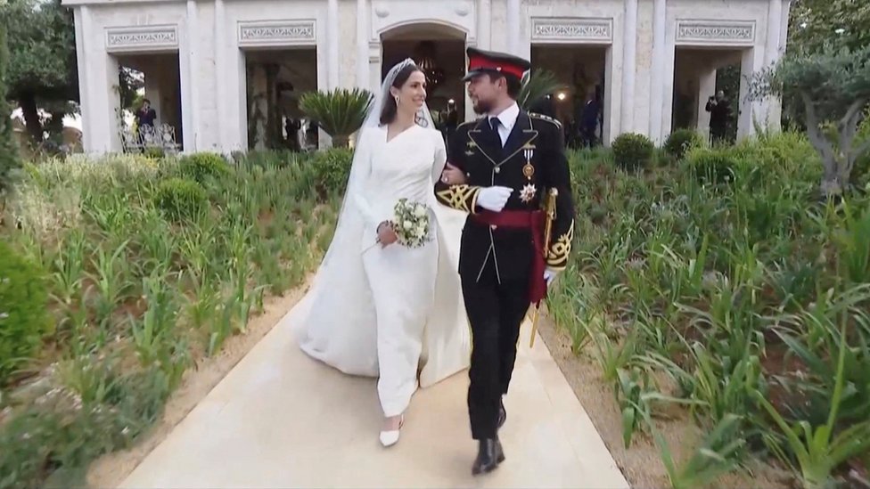bride and groom walking out of the palace after the wedding ceremony finished