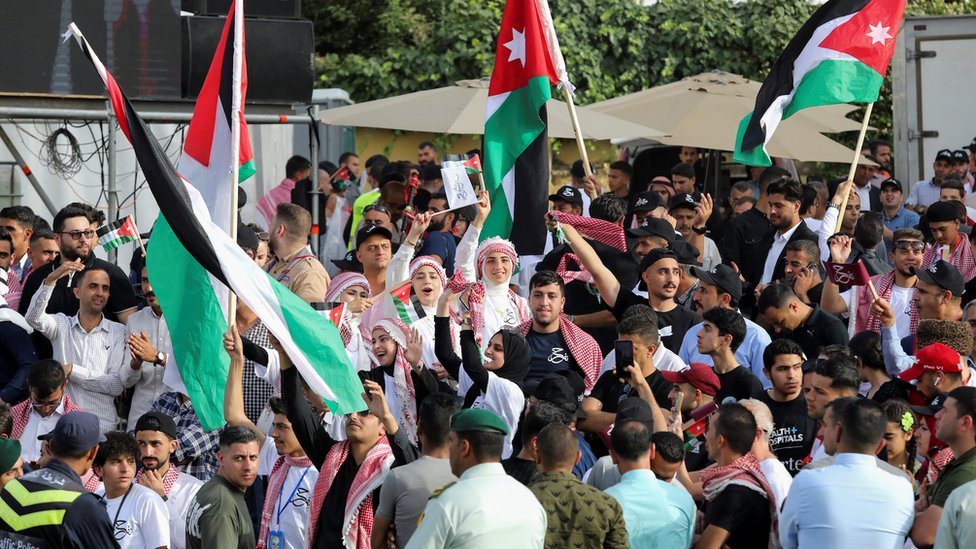 People gather in the streets of Amman during the wedding celebration