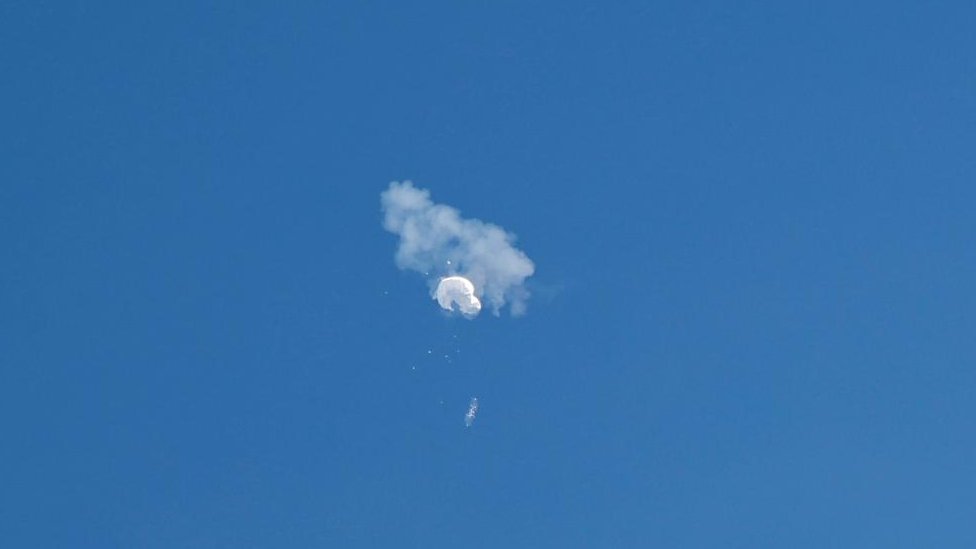 The suspected Chinese spy balloon drifts to the ocean after being shot down off the coast in Surfside Beach, South Carolina