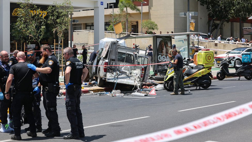 Members of Israeli security and emergency personnel work at the site of a reported car ramming attack in Tel Aviv