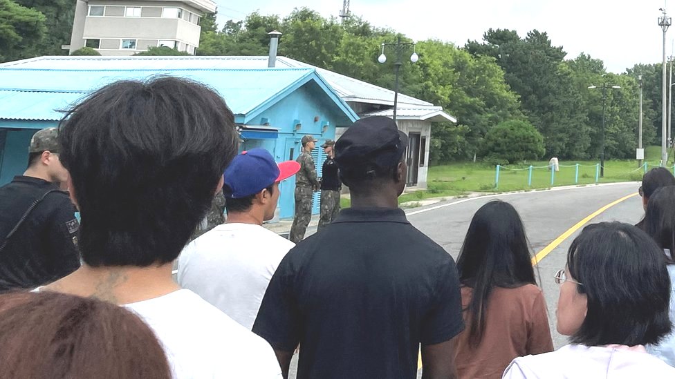 Travis King (wearing black shirt and black cap) on the border between the two Koreas, 18 July 2023