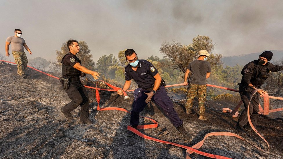 Toplotni talas ’Kerber’: Požari u Grčkoj se smiruju, evakuacija zbog eksplozija u vazduhoplovnoj bazi grčke vojske 8 Firefighters, volunteers and police officers move hoses