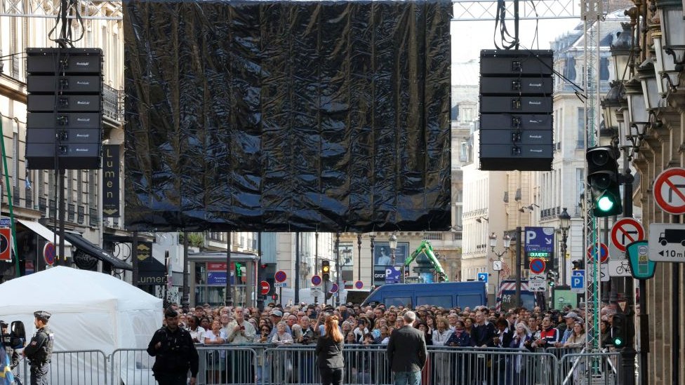 Crowds watch funeral on screen