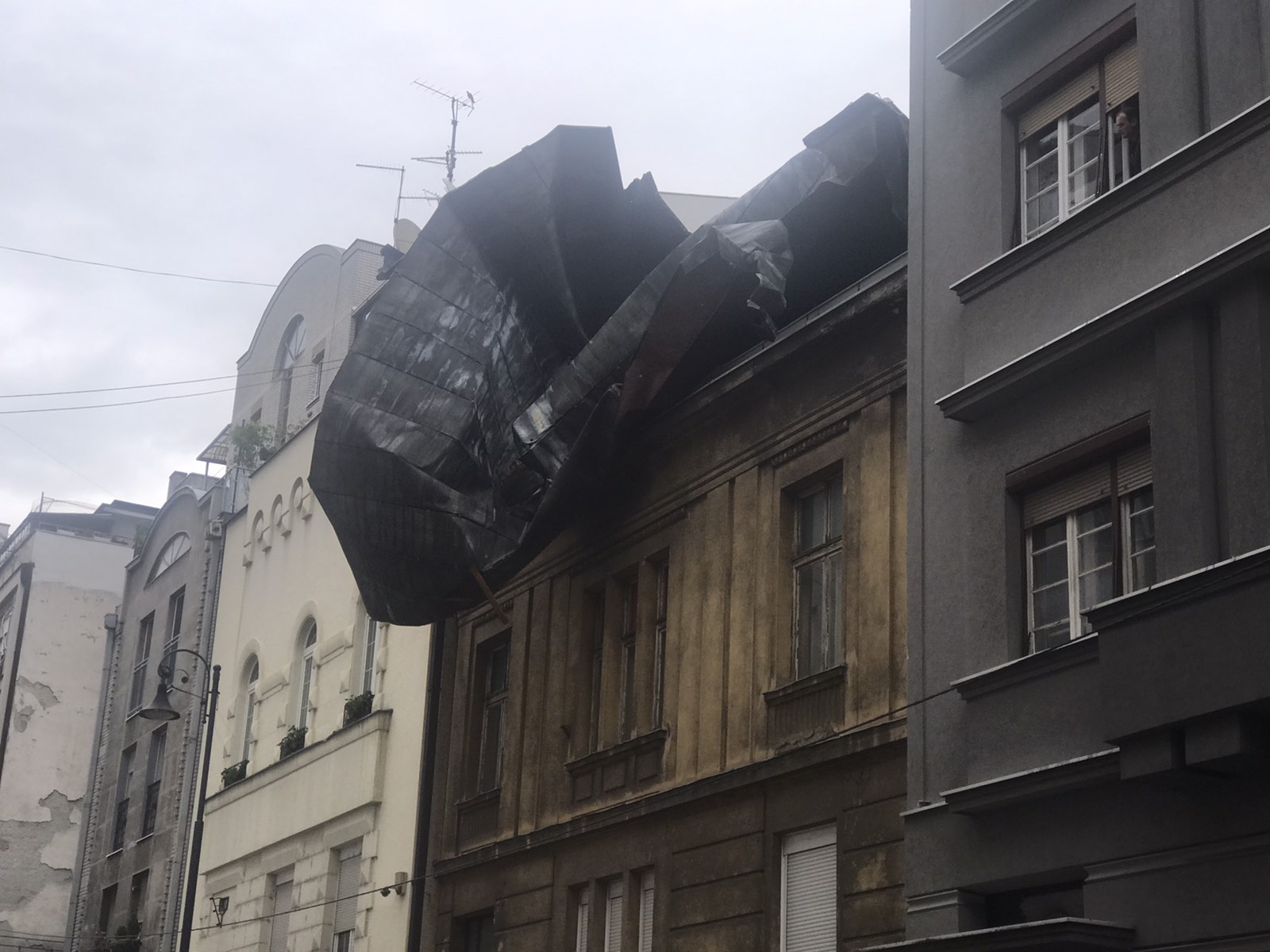(FOTO) Limeni krov posle oluje završio na susednoj zgradi, građani na Vračaru sami zatvorili ulicu daskama i kontejnerima 2