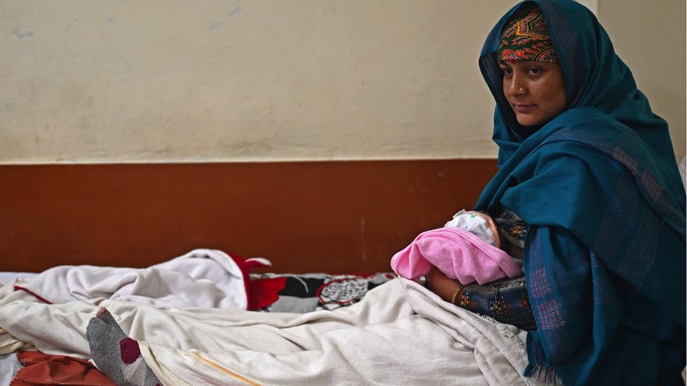A woman breastfeeds her newborn child inside a maternity ward of a civil hospital in Dehra, in Kangra district of India's Himachal Pradesh state.