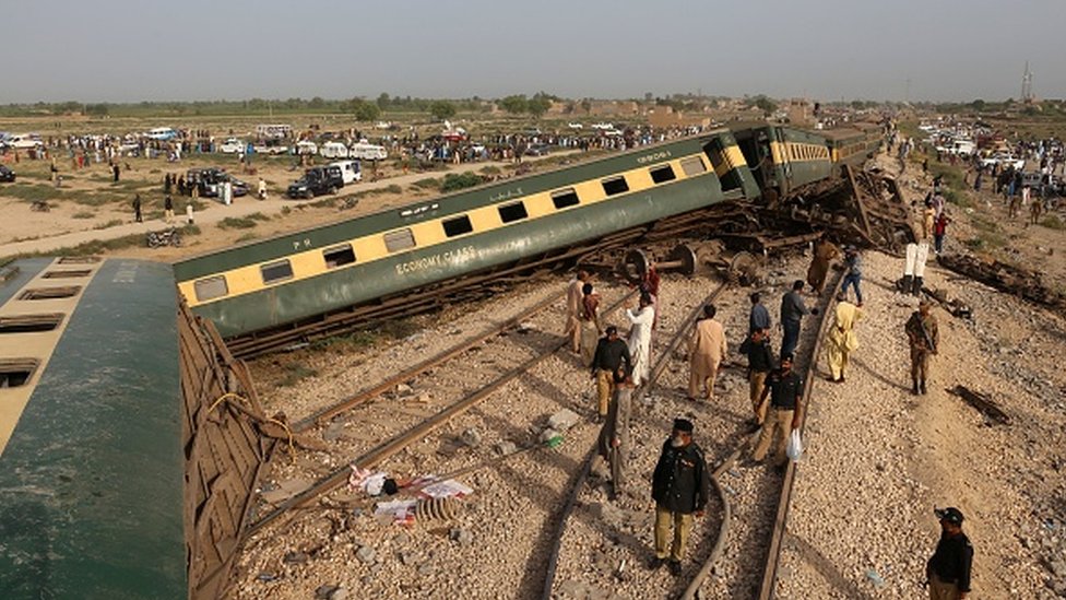 Police officials inspect the carriages at the accident site following the derailment of the train in Nawabshah on August 6, 2023