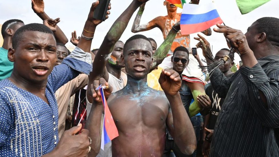 Supporters of Niger's National Council for the Safeguard of the Homeland (CNSP) wave Niger and Russian flags as they demonstrate in Niamey on August 6, 2023