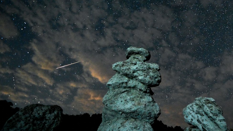 A long exposure photo shows meteor streaks crossing the night sky over the stone dolls in Kuklica, Republic of North Macedonia