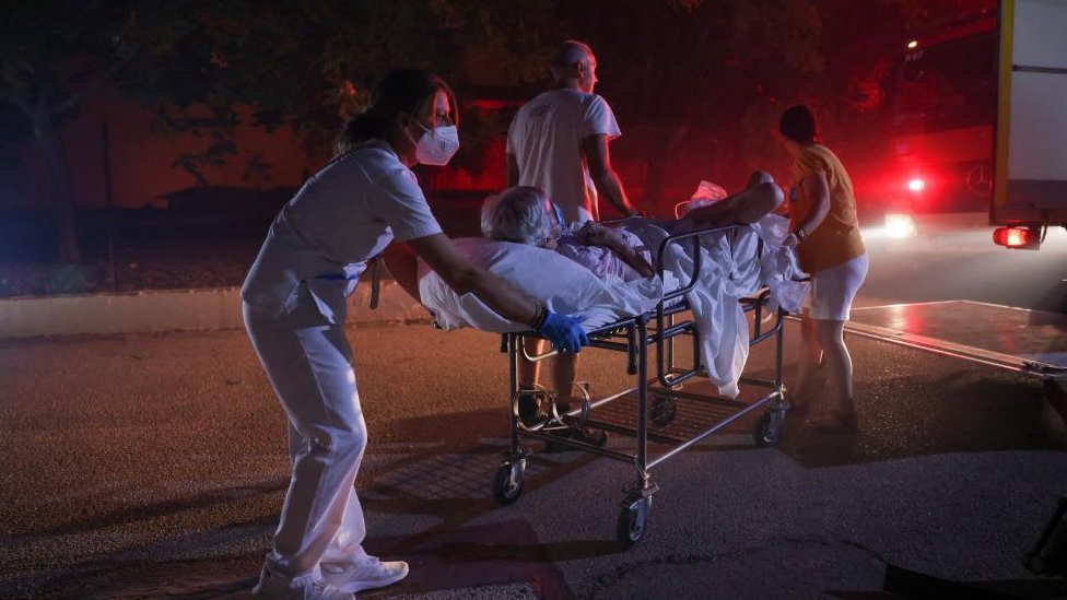 Patients of a chronic diseases management foundation get evacuated as a wildfire burns near Alexandroupoli, in the region of Evros, Greece, August 22, 2023