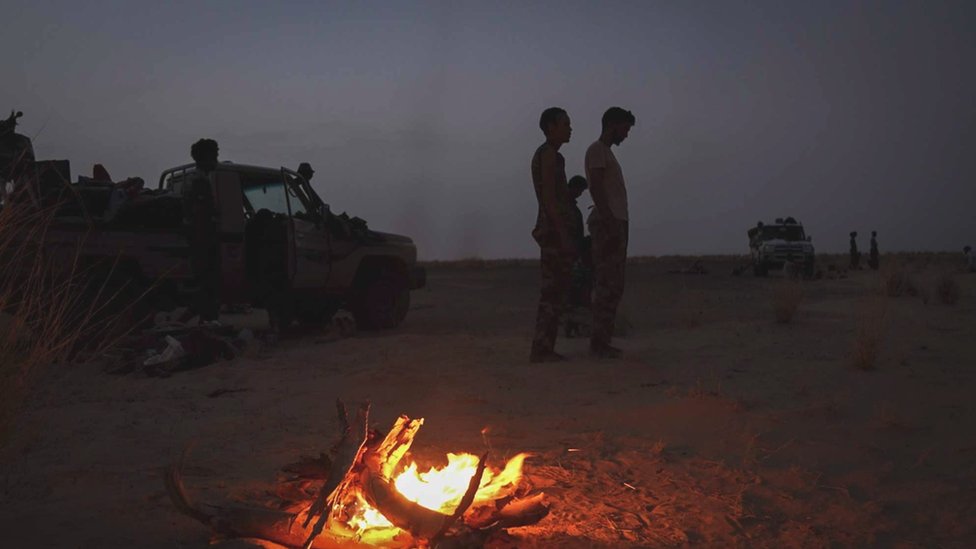 Afrika, Mali i smrt Prigožina: Šta će sada biti sa zemljom koja je bezbednost poverila ruskoj plaćeničkoj grupi Vagner 2 Vehicles and people near a camp fire in the desert