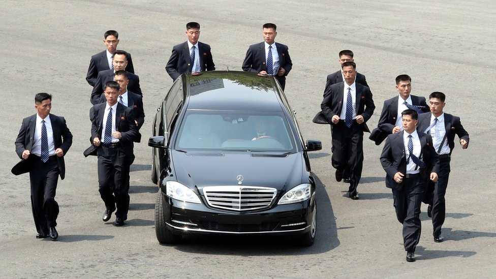 Kim Jong-un's Mercedes car flanked by bodyguards at the Inter-Korean summit