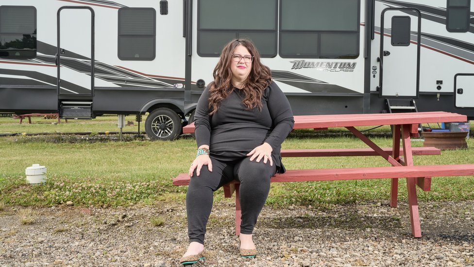 Kristan Hawkins sits in front of her motor home