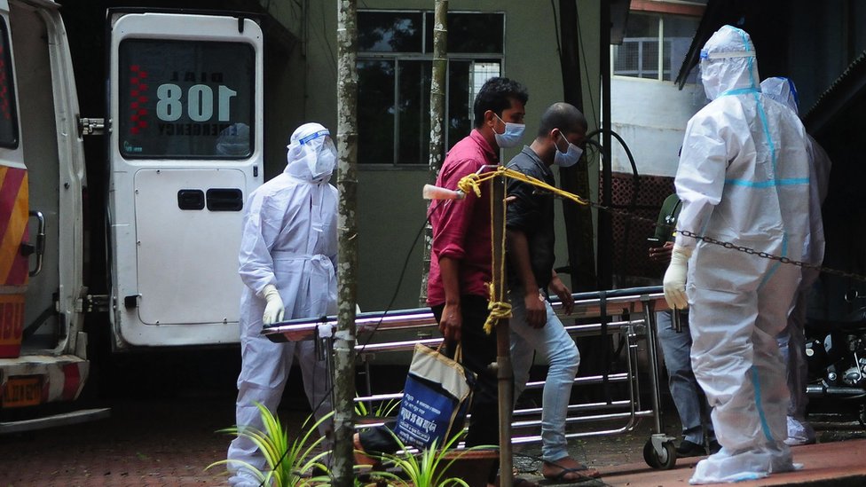 Health workers wearing protective gear shift people who have been in contact with a person infected with the Nipah virus to an isolation centre at a government hospital in Kozikode, in India's Kerala state on 14 September, 2023.