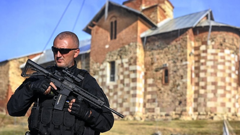 An armed Kosovo police officer stands guard along a road near the village of Banjska, Kosovo, 26 September 2023. A Kosovo Albanian police officer on 24 September was killed by Serb gunmen, who later barricaded themselves in the XIV century Serbian Orthodox Banjska monastery and traded gunfire with Kosovo police for hours. The police regained control of the area late on 24 September. The incident comes at a fragile moment in the Kosovo - Serbia European Union-facilitated dialogue to normalize ties between the two parties.