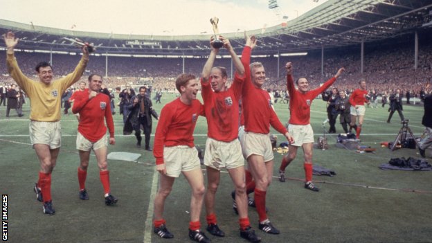 Bobby Charlton holds the World Cup trophy at Wembley after helping England win the final in 1966