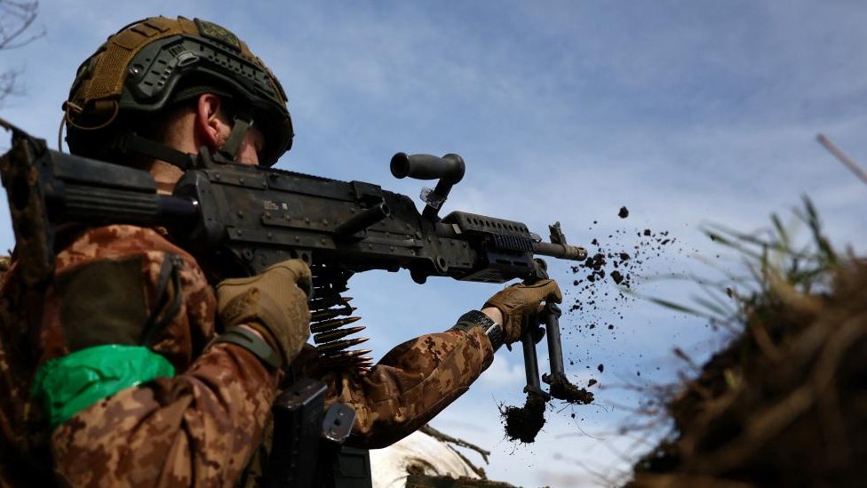 A Ukrainian soldier seen firing a gun