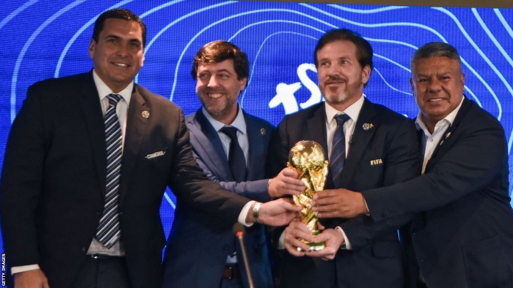 Paraguayan FA president Robert Harrison, Uruguayan FA president Ignacio Alonso, Conmebol president Alejandro Dominguez and Argentine FA president Claudio Tapia hold a replica World Cup trophy