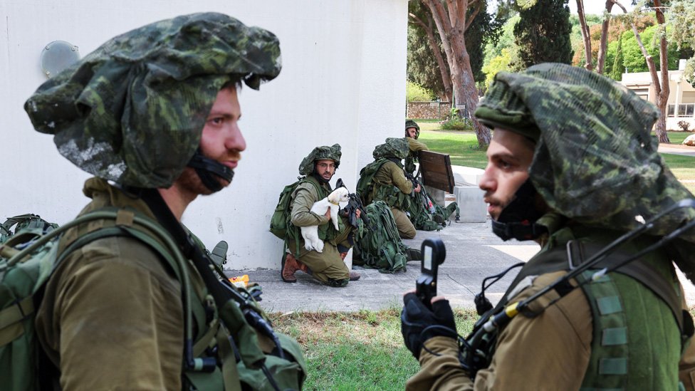 Israeli soldiers take position in Kfar Aza, in the south of Israel, bordering Gaza Strip