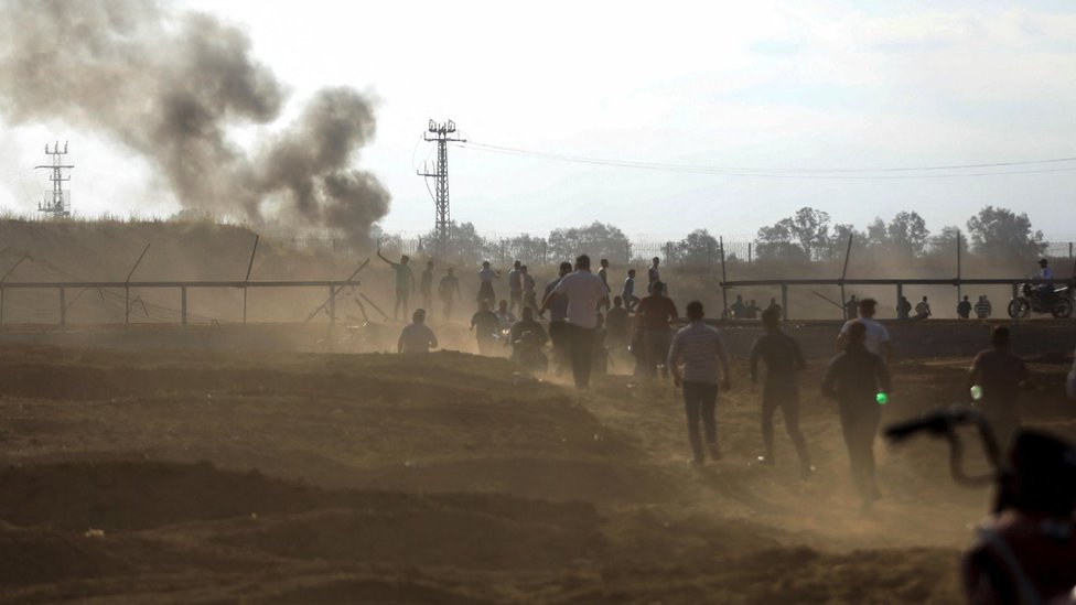 Palestinians break into the Israeli side of Israel-Gaza border fence after Palestinian gunmen infiltrated areas of southern Israel on Saturday 7 October 2023