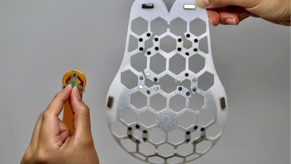 The small ultrasound scanner can fit in one of six slots to take an image of the breast