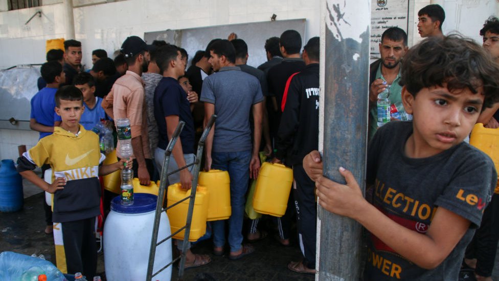 Palestinians fill up at one of the few water stations in Khan Younis.