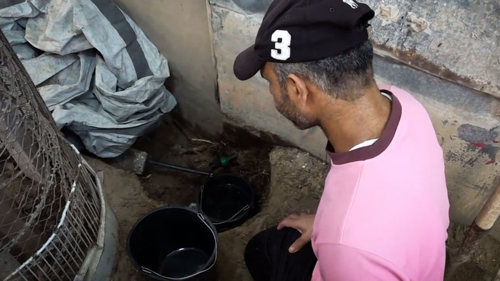 Abo Jamee trying to tease out the last drops of water