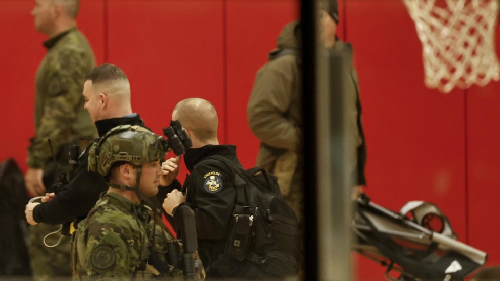 Armed police in basketball court