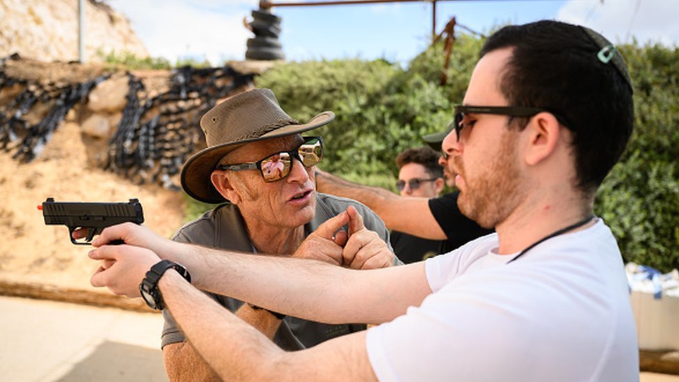 An Israeli citizen attends arms practice at a shooting range