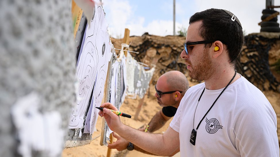 An Israeli citizen attends arms practice at a shooting range