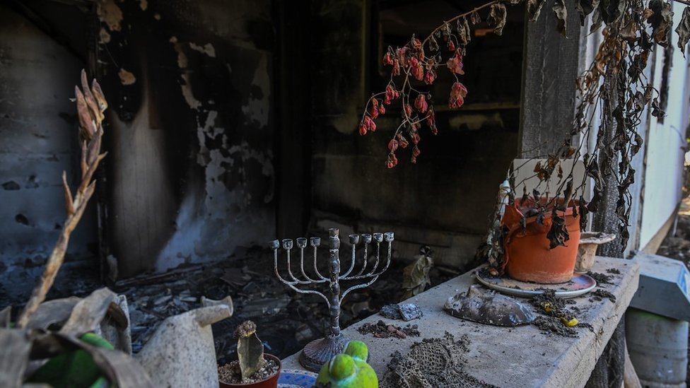 A Hanukkah menorah is left on a counter of a destroyed house after Hamas attacked this kibbutz on 7 October near the border of Gaza on 1 November 2023 in Kissufim, Israel.