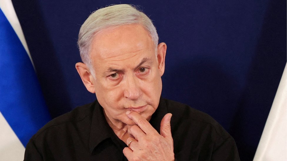 Benjamin Netanyahu during a press conference with a fingers on his lip