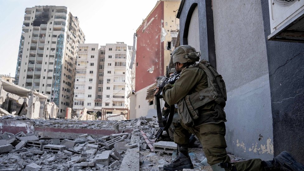An Israeli soldier takes position in the Gaza Strip as seen in a handout picture released by the Israel Defense Forces