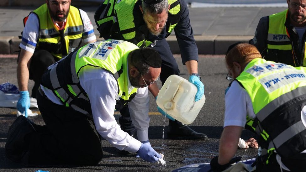 Israeli rescue teams inspect the scene of a shooting in Jerusalem near the Jewish settlement of Ramot, on November 30, 2023.