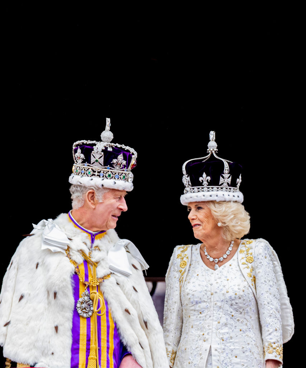 King Charles III and Queen Camilla wave at the balcony during the Coronation of King Charles III and Queen Camilla on May 6, 2023 in London, England.